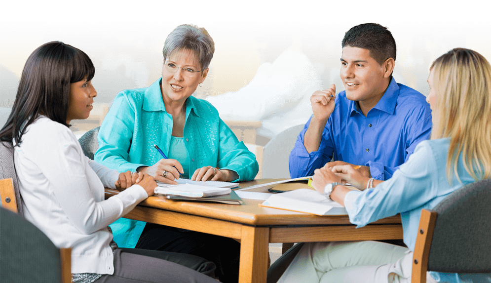 Admin-top-banner-tablet A group of educators talking