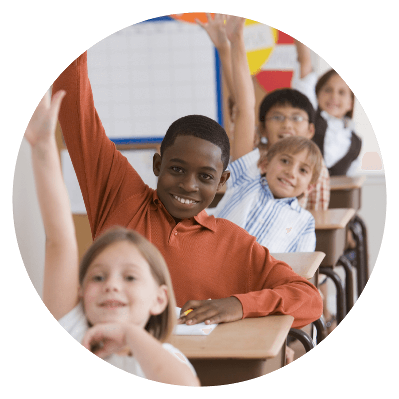 a group of middle school students raise their hand in class